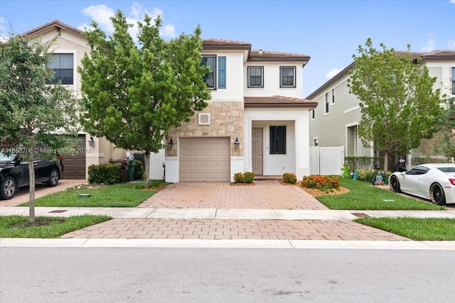 view of front of home with a front yard and a garage