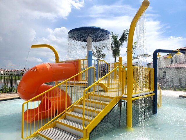 view of playground with a water view