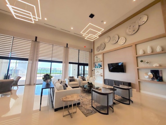 living room with a high ceiling and a wealth of natural light