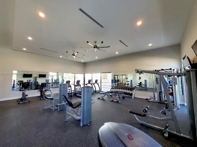 workout area featuring ceiling fan and a high ceiling