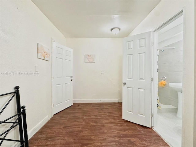 hallway with dark hardwood / wood-style flooring