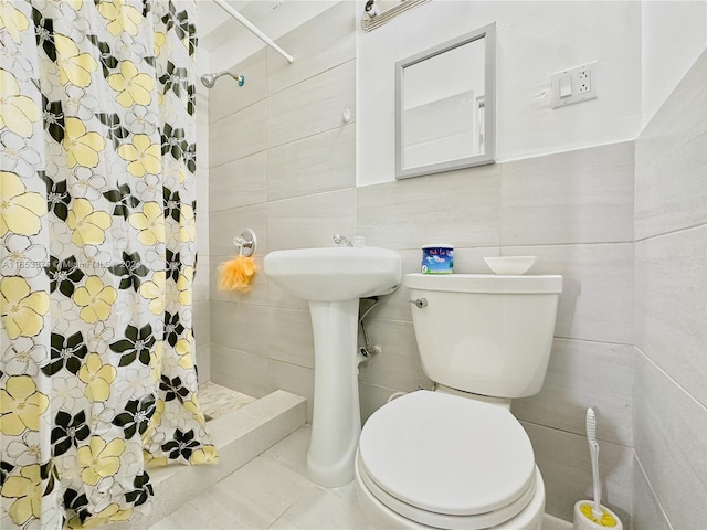 bathroom featuring tile walls, toilet, and walk in shower