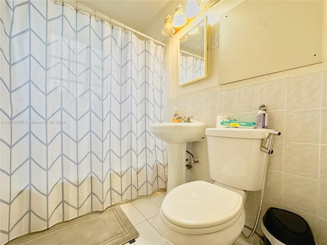 bathroom with a shower with shower curtain, tile walls, toilet, and tile patterned floors