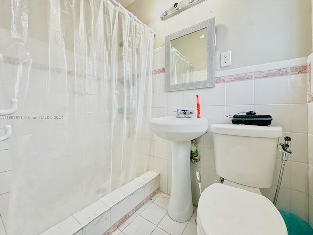 bathroom featuring tile walls, toilet, walk in shower, and tile patterned flooring