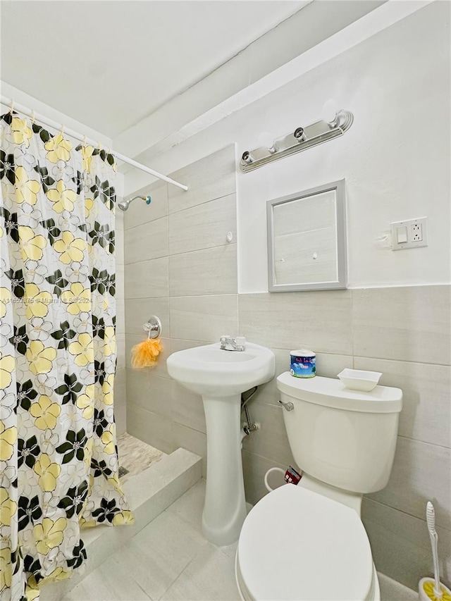 bathroom with tile walls, toilet, walk in shower, and tile patterned flooring