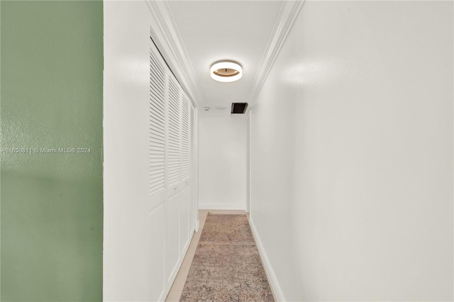 hall with light colored carpet and ornamental molding