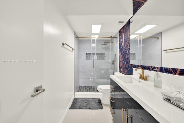 bathroom with vanity, toilet, and an enclosed shower