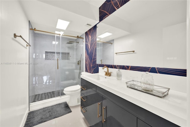 bathroom with walk in shower, toilet, and vanity