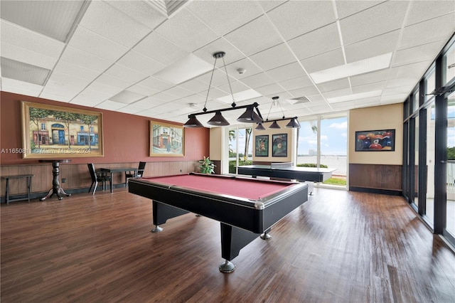 rec room featuring wooden walls, a drop ceiling, pool table, dark hardwood / wood-style flooring, and expansive windows