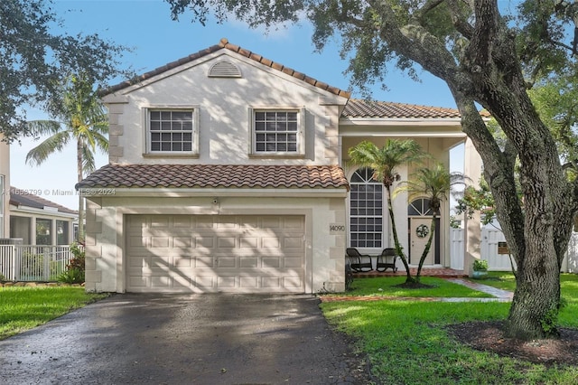 mediterranean / spanish-style house with a garage and a front yard