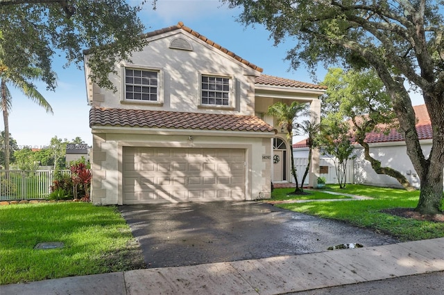 mediterranean / spanish-style house featuring a garage and a front yard