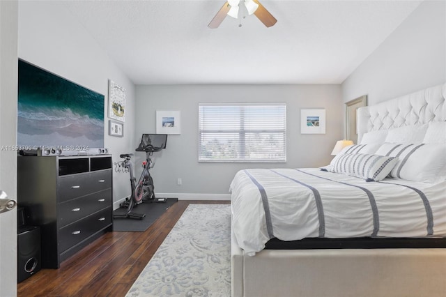 bedroom featuring ceiling fan, dark hardwood / wood-style floors, and vaulted ceiling