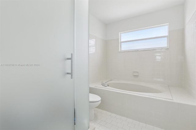 bathroom featuring plus walk in shower, toilet, and tile patterned floors