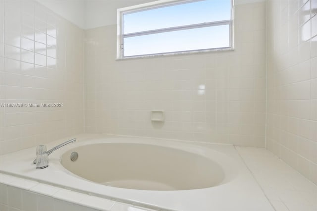 bathroom with tiled tub