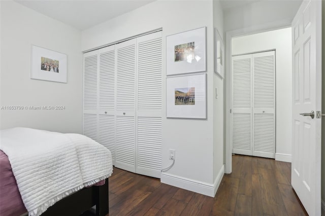 bedroom with dark wood-type flooring