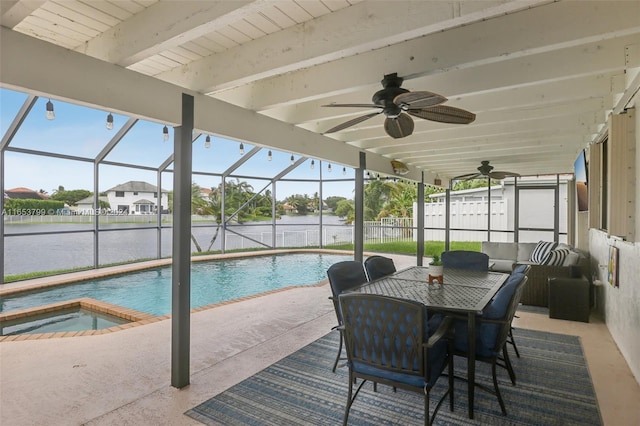 view of swimming pool featuring glass enclosure, a patio area, ceiling fan, and a water view