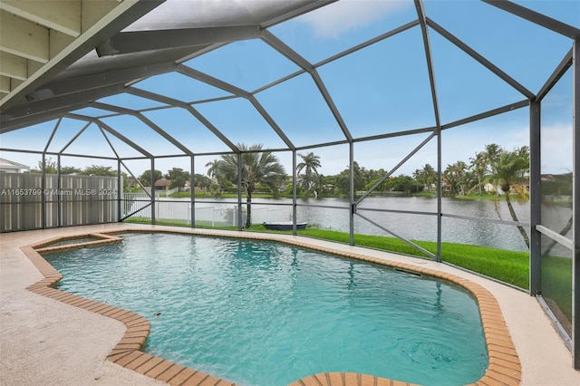 view of pool with a water view, a patio area, and glass enclosure