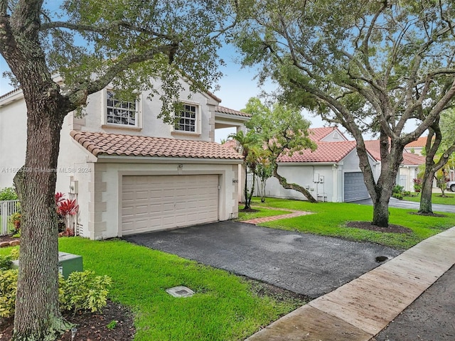 mediterranean / spanish-style house with a garage and a front yard