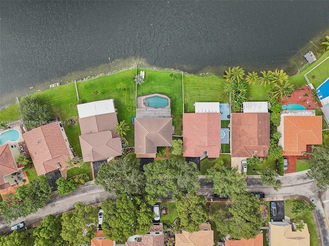 birds eye view of property with a water view