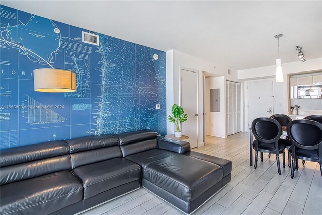 2602 E Hallandale Beach Blvd Unit R2304, Hallandale Beach, FL 33009 - living room with electric panel, wood finish floors, and an accent wall
