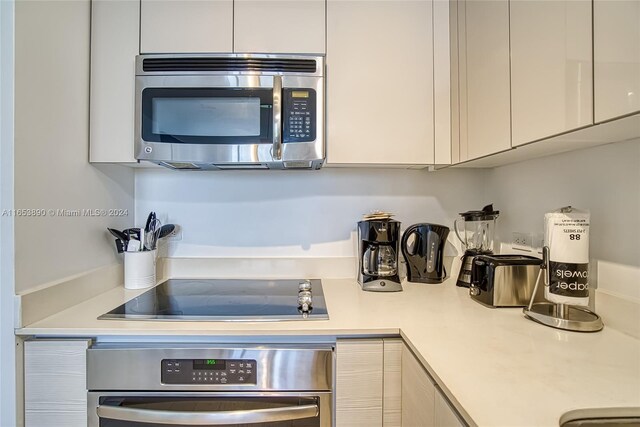 2602 E Hallandale Beach Blvd Unit R2304, Hallandale Beach, FL 33009 - kitchen featuring stainless steel appliances, light countertops, white cabinetry, and modern cabinets