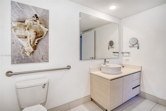 bathroom with tile patterned flooring, vanity, and toilet