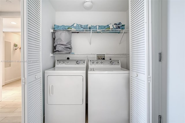 washroom featuring washing machine and clothes dryer and light hardwood / wood-style floors