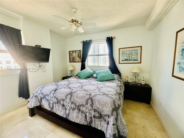 bedroom featuring a textured ceiling and ceiling fan