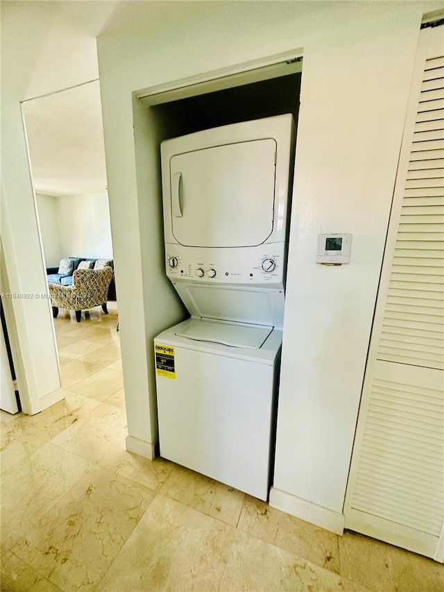 washroom with stacked washer and clothes dryer