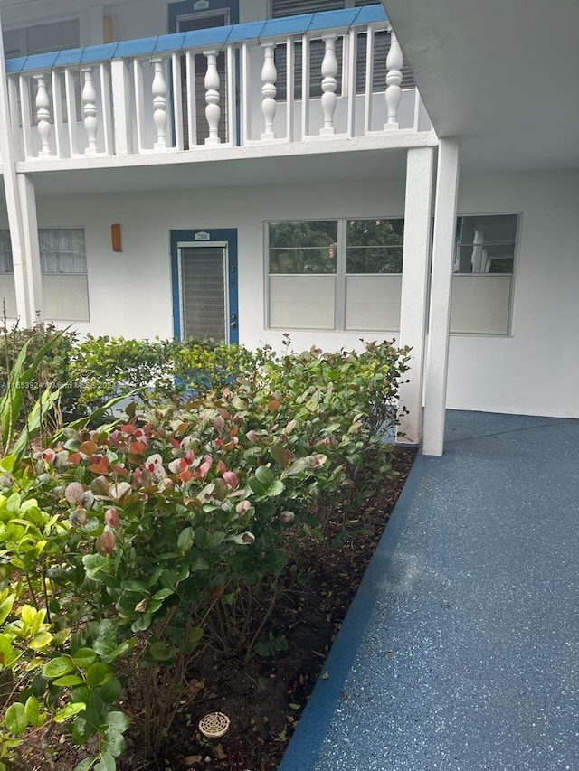 doorway to property featuring stucco siding