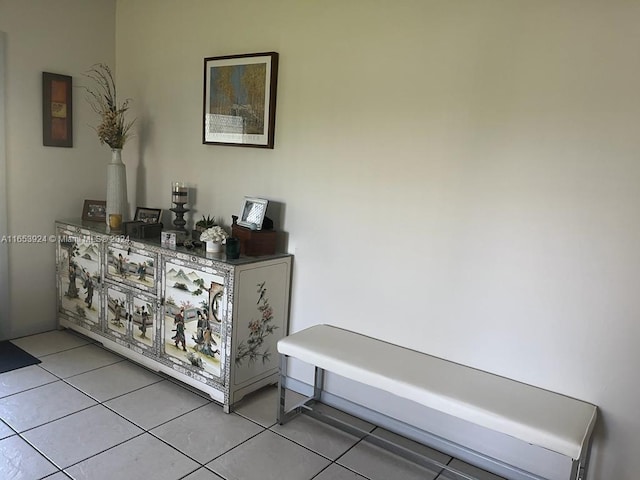 hall featuring light tile patterned flooring