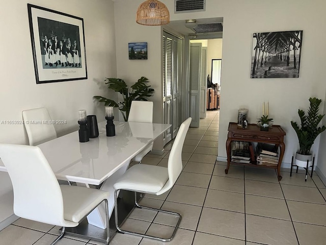 dining area with baseboards, visible vents, and tile patterned flooring