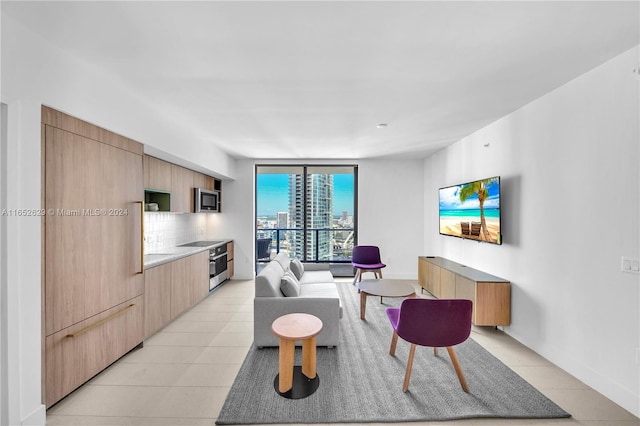 living room with a wall of windows and light tile patterned floors