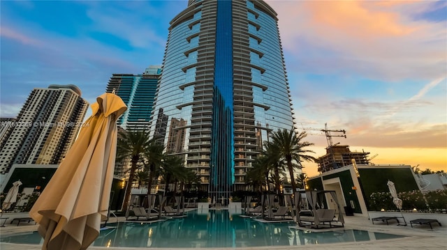 view of pool at dusk