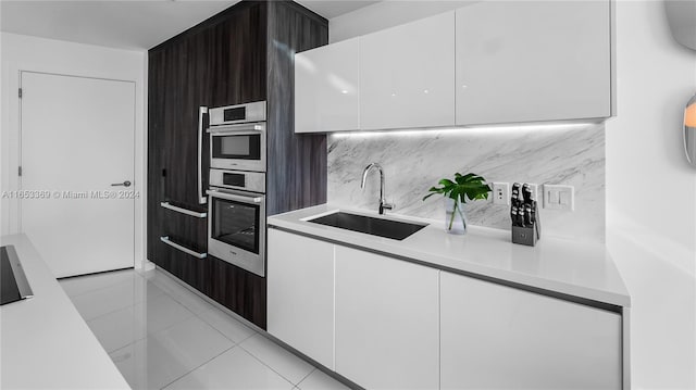 kitchen with white cabinets, modern cabinets, light countertops, and a sink