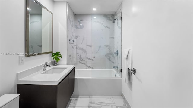 bathroom with washtub / shower combination, toilet, recessed lighting, marble finish floor, and vanity