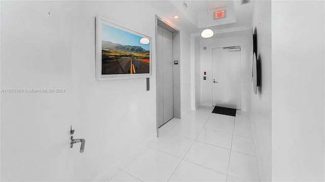 hall with elevator, light tile patterned floors, recessed lighting, and visible vents