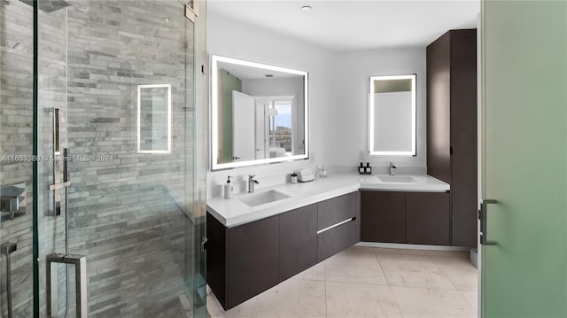 bathroom featuring double vanity, marble finish floor, a stall shower, and a sink