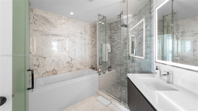 bathroom with marble finish floor, a stall shower, recessed lighting, a bath, and vanity