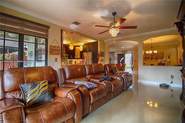 living room featuring ornamental molding, ceiling fan with notable chandelier, and a textured ceiling