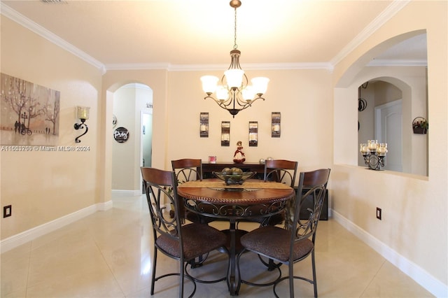 tiled dining area featuring crown molding and a notable chandelier