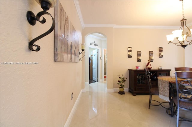 hall with crown molding and an inviting chandelier