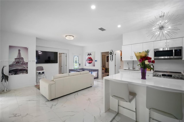 living room featuring a chandelier, recessed lighting, marble finish floor, and visible vents