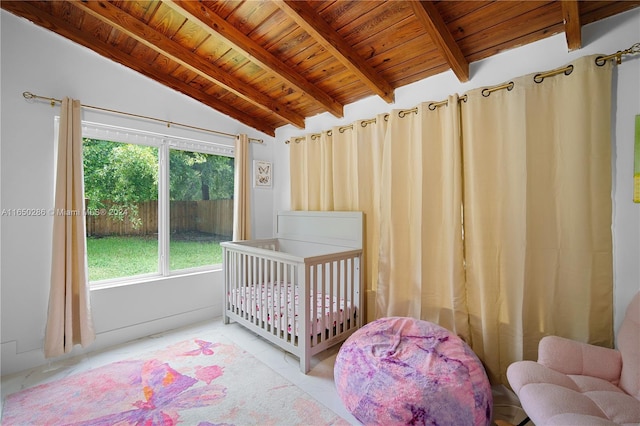 bedroom featuring multiple windows, a crib, lofted ceiling with beams, and wooden ceiling