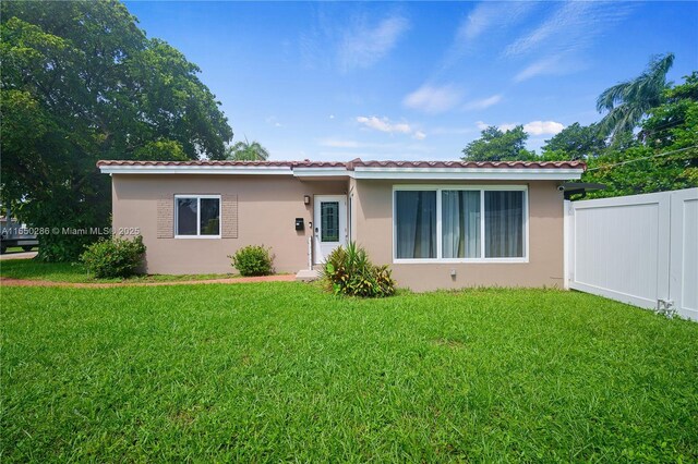 rear view of house with a yard