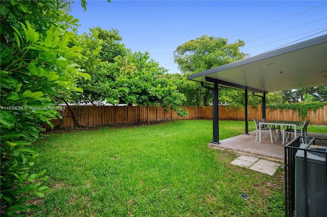 view of yard with central AC and a patio area