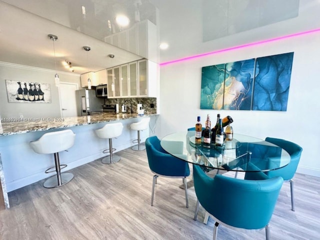 interior space featuring crown molding and light hardwood / wood-style floors