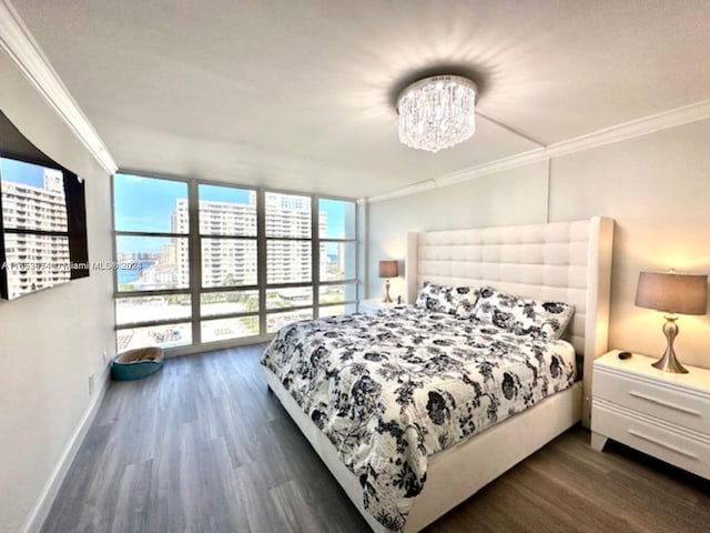 bedroom featuring expansive windows, dark hardwood / wood-style floors, an inviting chandelier, and crown molding