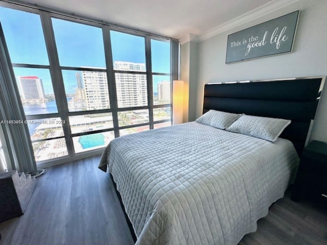 bedroom featuring expansive windows, dark hardwood / wood-style floors, and crown molding