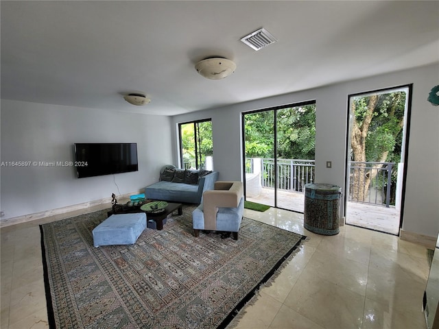 living room with light tile patterned flooring and a wealth of natural light